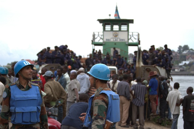 Government police arrive on a boat at goma port as U.N. peacekeepers watch on. Credit: William Lloyd-George/IPS