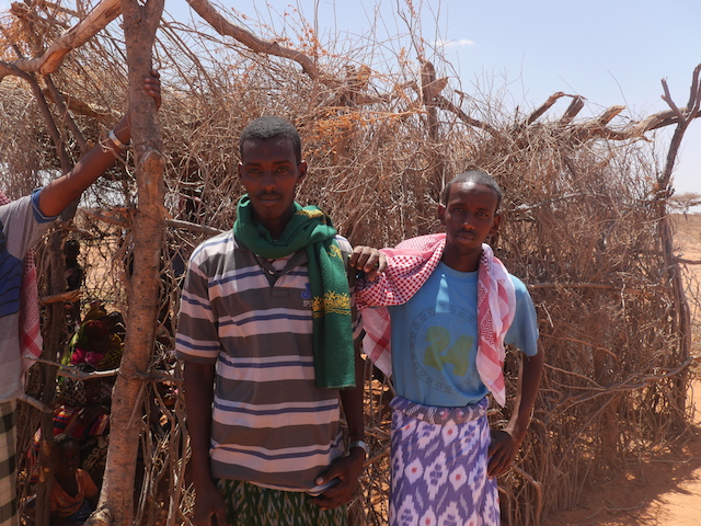 Abdi, 20 (right), standing outside his class with a friend. His pastoralist community, situated here outside the town of Shilabo in Somali Region, Ethiopia, has a teacher who now travels with them. Credit: William Lloyd-George/IPS