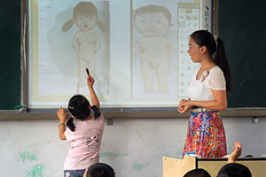 As part of student sexual safety training at Yindian Central Primary School, in Suizhou, central China, a 6-year-old girl circles the private parts of a human body after having learned how to identify them on female and male human bodies. Credit: Xinyu Zhang