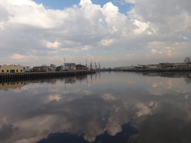 An industrial area along the Riachuelo, with the port in the background, in Buenos Aires. Since the first factories were built along the banks in 1801, industrial waste has been dumped into the river. There are now 15,000 factories, of which 459 were reconverted to prevent them from polluting, while another 1,300 are in the process of doing the same. Credit: Fabiana Frayssinet/IPS