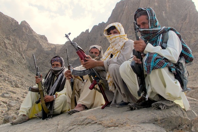 Baloch fighters from the Balochistan Liberation Army crouch at an undisclosed location along the Afghan-Pakistan border. There are several Baloch insurgent groups fighting for independence in Pakistan. Some of their fighters often cross the border to evacuate the wounded and treat them in Afghan hospitals. Credit: Karlos Zurutuza/IPS