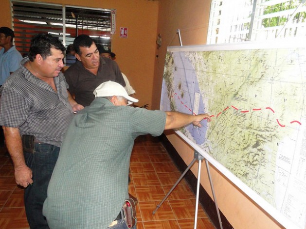 Three farmers study the route for the interoceanic canal on a map of Nicaragua, which the Chinese firm HKND Group presented in the southern city of Rivas during one of the meetings that the consortium has organised around the country with people who will be affected by the mega-project. Credit: José Adán Silva/IPS