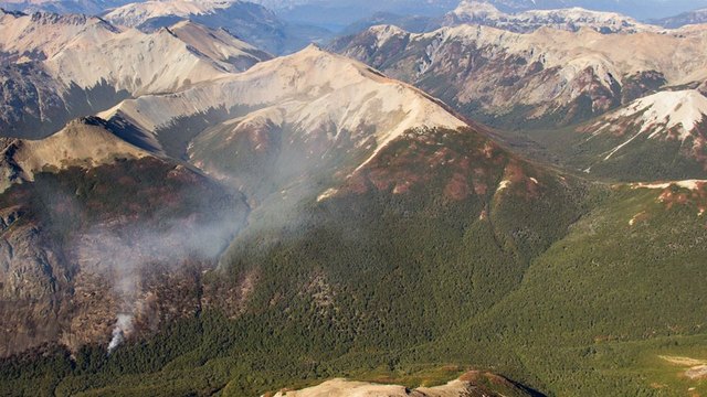 An isolated hotspot throws up smoke in the Alerce River valley on Mar. 11, after some rain fell in the area. Argentina's southern Patagonia region suffered the worst forest fire in the country's history. Credit: Courtesy of Daniel Wegrzyn