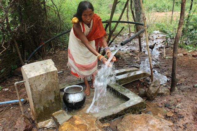 A major reason for the Dongria Kondh's opposition to Vedanta Resource's bauxite mining in the Niyamgiri Mountains in the eastern Indian state of Odisha was that it would destroy their numerous perennial hill streams. Here, a tribal girl washes at a pipe that gushes fresh water 24 hours a day. Credit: Manipadma Jena/IPS