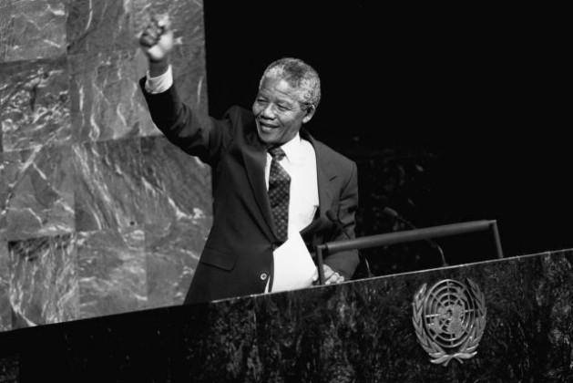 Nelson Mandela, then Deputy President of the African National Congress of South Africa, raises his fist in the air while addressing the Special Committee Against Apartheid in the General Assembly Hall, June 22, 1990. Global alliance CIVICUS commemorated Mandela Day with a reminder that many rights defenders are jailed and intimidated. Credit: UN Photo/Pernaca Sudhakaran