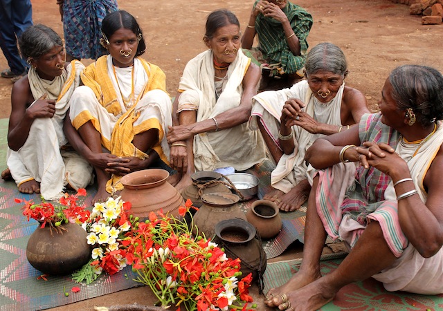A group of priestesses discuss their plans before setting off in search of ‘vanishing' millet varieties from a neighbouring village in eastern India. Credit: Manipadma Jena/IPS