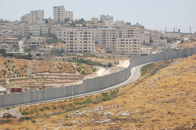 The separation wall runs between the Israeli settlement of Pisgat Ze'ev and a Palestinian refugee camp. Credit: Jillian Kestler-D'Amours/IPS