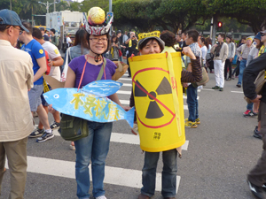 &quot;We don`t want nuclear waste,&quot; say two  Taiwanese women during a demonstration against nuclear power in Taipei on March 8, 2015. The flying fish and nuclear waste barrel refer to the &quot;low-level&quot; radioactive waste disposal facility set up in 1984 by the state-run Taiwan Power Co on Lanyu (Orchid Island) off Taiwan`s southeast coast that is opposed by the island`s indigenous Dawu people.  Credit: Dennis Engbarth/IPS