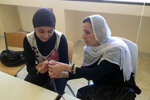 Hiba Kamal, a Syrian refugee, learns needlework technique from a Lebanese woman at a workshop by Amel Association, supported by UN Women Fund for Gender Equality. Photo courtesy of Amel Association