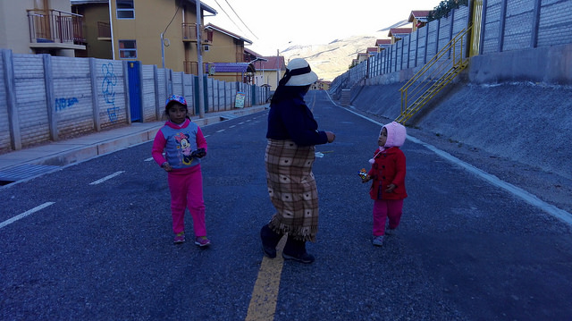  Two girls with their mother on a street of Nueva Fuerabamba, the town where the relocated Quechua villagers were transferred because of the open-pit copper mine in Las Bambas, removed from their traditional way of life, in the department of Apurímac, in the Andean highlands of southern Peru. Credit: Milagros Salazar/IPS
