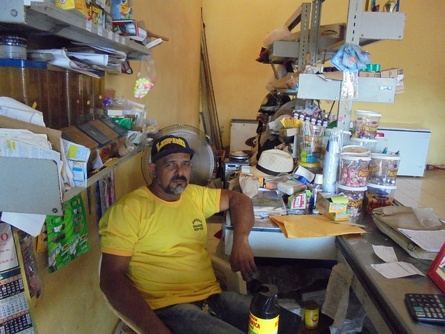 Carlos Damasceno in his store, which provides gas, food and other goods to the people of Vila Nova Teotônio. The town was built with 72 houses to resettle the villagers who lived along the Madeira River, in communities that were flooded by the Santo Antônio hydropower plant reservoir, in the northwest of Brazil. Credit: Mario Osava/IPS