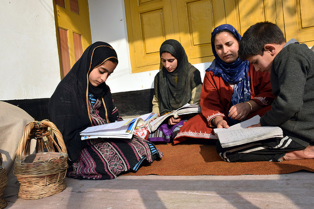 Mariya, Arjumand and Fazl Sareer, students from the village of Shurat in India's Kashmir valley, study at their home. Educational institutions have been closed for four and half months due to political unrest in the state. Credit: Stella Paul/IPS