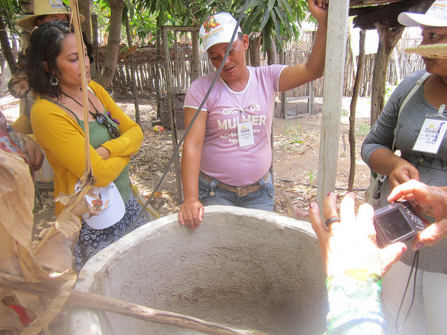   Antonia Damiana da Silva (C) proudly explains how her biodigester uses the manure from her small livestock to produce cooking gas for her family in the rural settlement where she lives in the state of Rio Grande do Norte in the Northeast of Brazil. Credit: Mario Osava/IPS