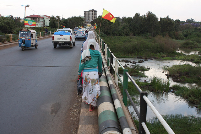 Ethiopian national flags and regional Amhara flags flutter along the bridge over the Blue Nile on the road going east from Bahir Dar that the protesters took last year. Credit: James Jeffrey/IPS