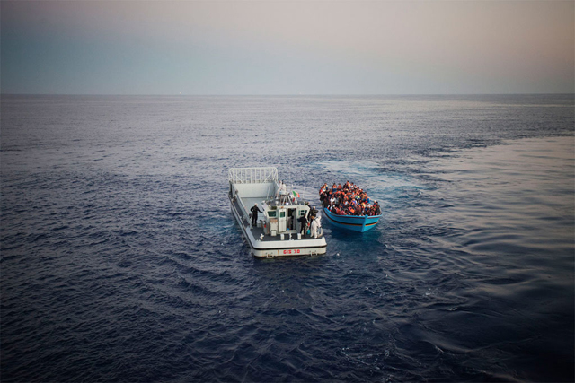Risking their lives to reach Europe from North Africa, a boatload of people, some of them likely in need of international protection, are rescued in the Mediterranean Sea by the Italian Navy. Credit: UNHCR/A. D&#039;Amato
