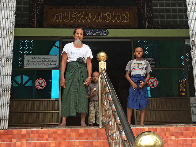 U Wai Li Tin Aung, secretary of the Joon Mosque, the biggest in Mandalay, Myanmar, stands on the entrance steps with two of his children. Credit: Pascal Laureyn/IPS