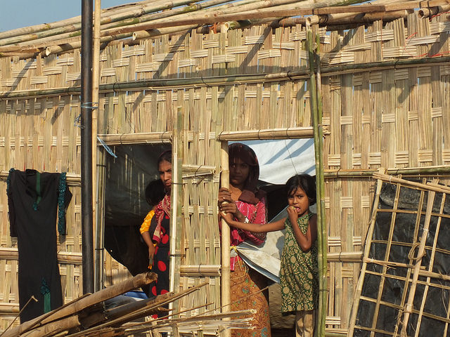 Rohingya women stand next to their partially constructed new home in Kutupalong camp, Bangladesh. Credit: Naimul Haq/IPS