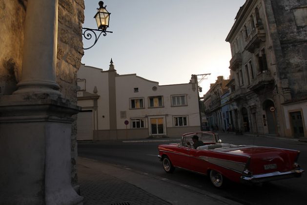 A classic 1957 convertible Chevrolet Bel-Air, used by private drivers for sightseeing tours, drives through the historic centre of Old Havana in search of customers, now that the boom of visits by U.S. citizens has ceased. Credit: Jorge Luis Baños / IPS