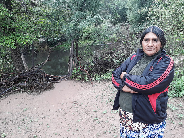Dorita, a local indigenous woman, stands in front of a &amp;quot;represa&amp;quot; or pond dug near her home, in Lote 6, a Wichí community a few kilometres from the town of Los Blancos, in Argentina's Chaco region. The ponds accumulate rainwater and are used to provide drinking water for both animals and local families, posing serious health risks. Credit: Daniel Gutman/IPS
