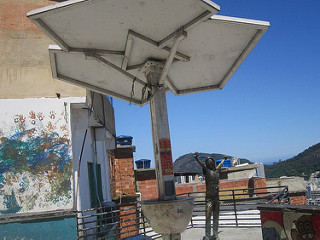 A view of the terrace with the statue of late American pop star Michael Jackson, who in 1996 shot a video clip in Santa Marta, which turned this poor neighborhood on a hill of Rio de Janeiro into a tourist attraction. In front, the &amp;quot;solar tree&amp;quot;, with photovoltaic panels and a battery to generate electricity capable of providing illumination in case of emergency, such as the blackouts, and with plugs to charge mobile devices. Credit: Mario Osava/IPS