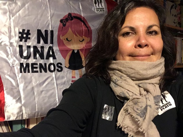 Rocío Silva, a university professor and women's rights activist, stands in front of a poster highlighting #NiUnaMenos, the anti-femicide movement that has emerged in several Latin American countries. Credit: Courtesy of Rocío Silva