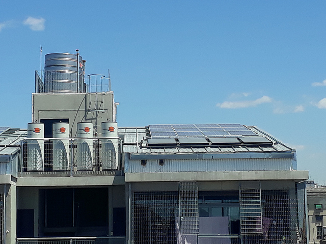 A total of 174 solar panels and 55 solar-powered water heaters were installed on the rooftops of the new social housing complex in Villa 31, in the Argentine capital. Each water heater has a capacity of 300 liters and supplies two homes, based on the estimate of an average of three people per apartment, who use 50 litres of hot water a day. Credit: Daniel Gutman/IPS