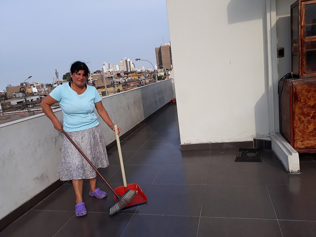 Blanca Garcia, 50, sweeps the terrace of a middle-class home in Lima. She works as a housekeeper in several homes in Peru's capital. Her main motivation is to ensure her 14-year-old daughter a good education, to make it possible for her to have a future job with full rights and opportunities. Credit: Mariela Jara/IPS