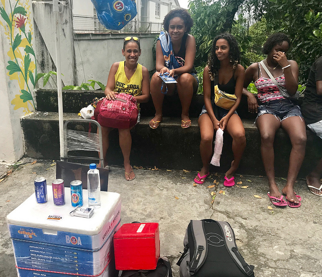 Young street vendors take a break in the traditional neighborhood of Santa Teresa during the 2019 Rio de Janeiro carnival in Brazil. Data from U.N. Women indicate that 60 percent of Latin American women work in the informal sector. Greater participation in technology can mitigate the poor working conditions faced by women. Credit: Fabiana Frayssinet/IPS