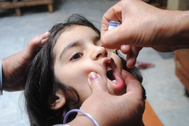 A Pakistani child receives a dose of oral polio vaccine (OPV).  Credit: Ashfaq Yusufzai / IPS