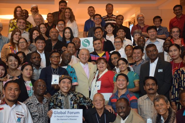 Participants from organisations focused on assisting Hansen’s disease-affected people from Asia, Latin America and Africa with World Health Organisation (WHO) Goodwill Ambassador for Leprosy Elimination, Yohei Sasakawa (centre pink shirt) pictured in 2019. Participants were attending the Global Forum of People’s Organisations on Hansen’s disease in Manila, Philippines, which was sponsored by the Sasakawa Health Foundation and The Nippon Foundation. Credit: Stella Paul/IPS