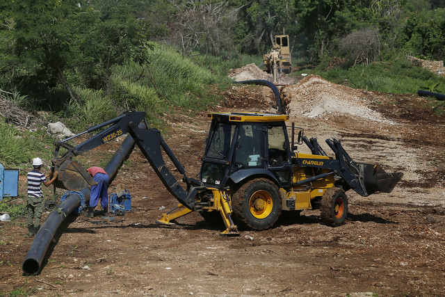 Workers of the Aguas de La Habana water company lay a high-density polyethylene pipe to supply drinking water in the Peñas Altas district, near Guanabo beach, in eastern Havana. Part of the hydraulic investments made by Cuba in the sector are supported by international cooperation through projects and funds from other countries and international organisations. CREDIT: Jorge Luis Baños/IPS