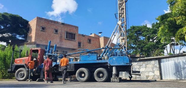 A truck with a crane is positioned next to a house to start drilling a well in search of water, which is abundant under the ground in the Caracas valley. CREDIT: Courtesy of José Manuel García
