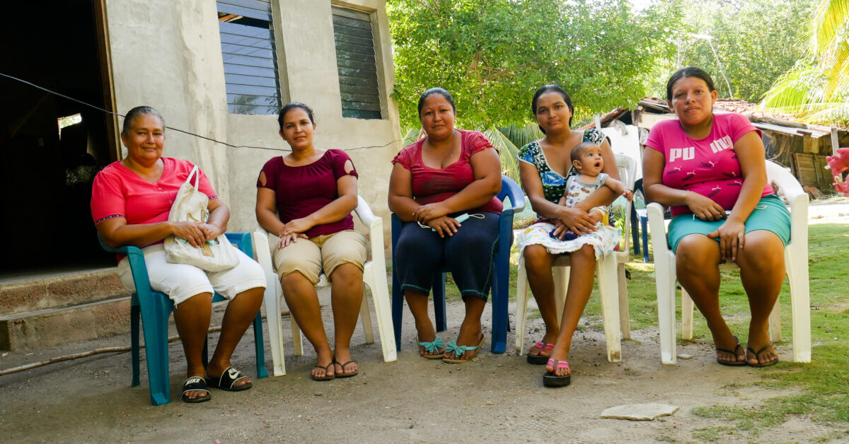 A group of women from the community of El Mozote, on the Salvadoran coast, express their concern about the uncertainty of not knowing if they will be evicted from their homes built on a plot of land claimed by a real estate company. They are asking the authorities to carry out a complete survey of the land. CREDIT: Edgardo Ayala/IPS
