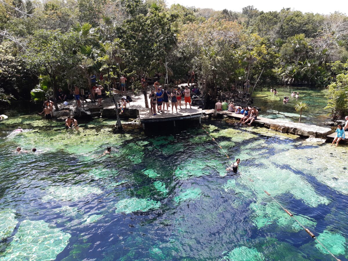 The Mayan Train, which will run 1,500 kilometers through five states in southern and southeastern Mexico, threatens ecosystems and tourist attractions, such as subterranean caves and cenotes. The photo shows tourists swimming in the cenote Azul, on the outskirts of Playa del Carmen, in the southeastern state of Quintana Roo on the Yucatan Peninsula. CREDIT: Emilio Godoy/IPS