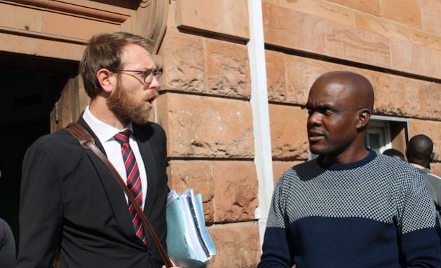 Journalist Jeffery Moyo, with his lawyer, Doug Coltart, outside the Magistrates' Court, Bulawayo, Zimbabwe.  Moyo faces charges of violating Section 36 of the Immigration Act.  His sentencing date is scheduled for May 31, 2022. Source: Busani Bafana/IPS