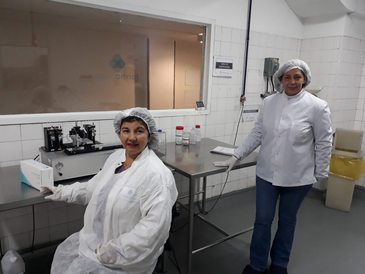 Edith Pereira (seated) and Blácida Benitez, two of the members of Farmacoop, a laboratory recovered by its workers in Buenos Aires, are seen here in the production area. This is the former Roux Ocefa laboratory, which went bankrupt in the capital of Argentina and was left owing a large amount of back wages to its workers. CREDIT: Daniel Gutman/IPS