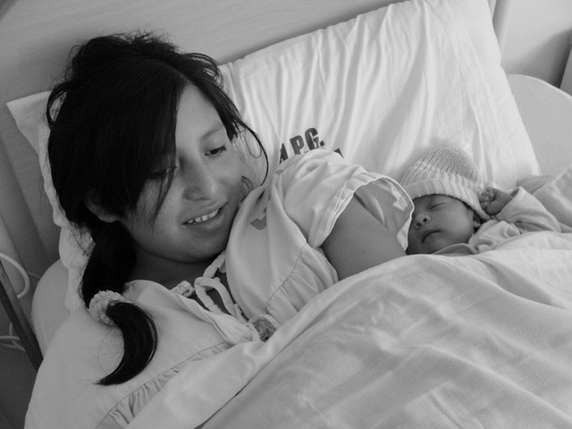 Miriam Toaquiza, a teenage mother and her newborn daughter, Jennifer, are pictured at a hospital in Ecuador.  Latin America ranks second in the world in terms of teen pregnancy rates, one of the causes of high maternal mortality rates in the region.  CREDIT: Gonzalo Ortiz / IPS