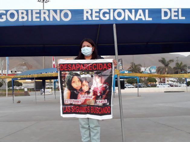 Patricia Acosta, Estéfhanny Díaz's mother, carries a poster with a photo of her daughter and granddaughters Tatiana and Yamile. The three disappeared six years ago and so far the authorities, in her opinion, have done little to find them. Acosta, 50, poses in the Plaza Cívica de Ventanilla, a district of the port city of Callao, next to the Peruvian capital. CREDIT: Mariela Jara/IPS