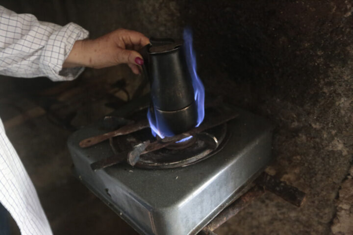 Mayra Rojas turns on biogas on her small stove to brew coffee in her home in the rural community of Carambola, in the municipality of Candelaria, in the western Cuban province of Artemisa. She says that with this clean energy source she spends less time cooking and saves electricity. CREDIT: Jorge Luis Baños/IPS