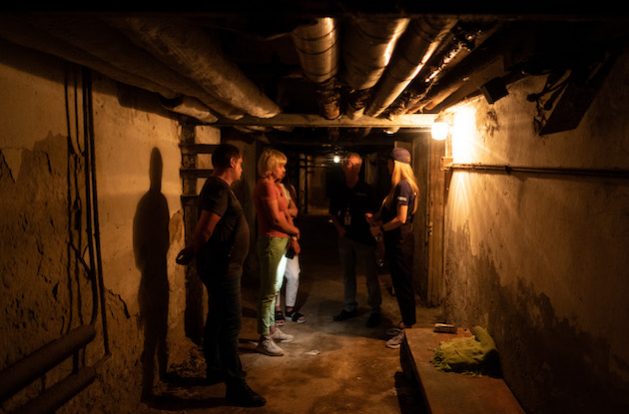 Dr Svetlana Alexandrova, Medical Director of the Chernihiv Psychoneurological Hospital, and Yevgen Skydan, Technical Specialist, walk Todd Bernhardt and his team through the basement where patients and staff were sheltered during the Russian invasion. Credit: International Medical Corps