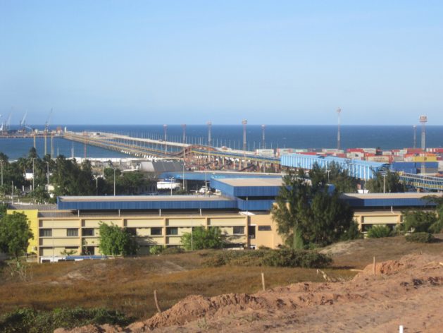 View of the port of Pecém, in the state of Ceará in northeastern Brazil, with its container yard and the bridge leading to the docks where the ships dock, in the background. Minerals, oil and gas, steel, cement and wind blades are some of the products imported or exported through what is the closest Brazilian port to Europe. CREDIT: Mario Osava/IPS