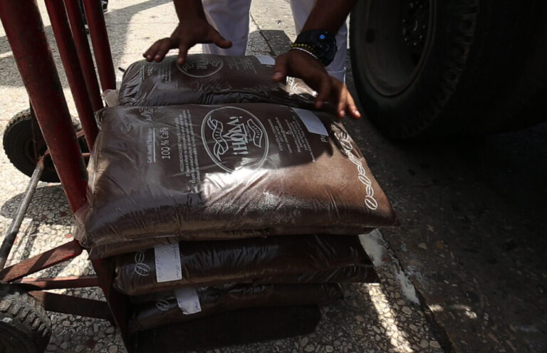 Bags of coffee are stacked in a wheelbarrow for later sale at a state-run establishment in Havana's Vedado neighborhood. The government provides 115 grams of coffee per month to Cuban families at subsidized prices, but in recent months it has been delivered with delays due to difficulties in obtaining supplies. CREDIT: Jorge Luis Baños/IPS