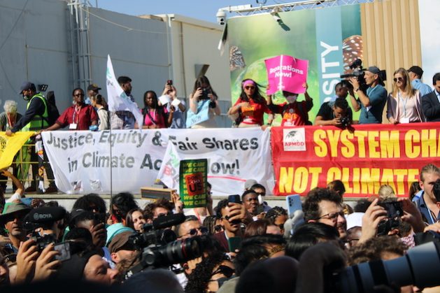 Climate change activists at COP27, Sharm El Sheikh, Egypt. Negotiators which struggled to complete reach agreement on the critical loss and damage fund demanded by developing nations most affected by climate change. Credit: Busani Bafana/IPS