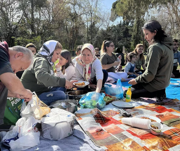 Afghan refugees picnic in a park in Athens. Their journeys to Europe are often dangerous. Credit: Sara Perria/IPS