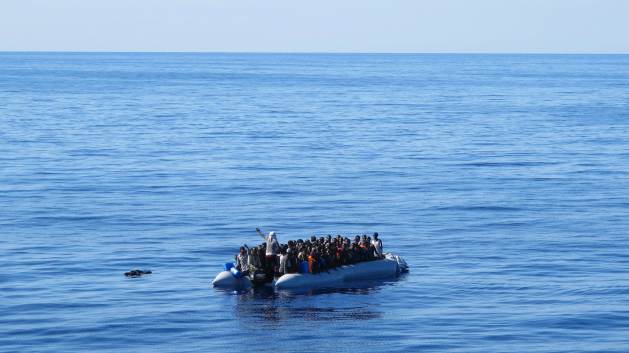 Migrants spotted aboard a sinking dinghy boat somewhere off the Libyan coast. Credit: Karlos Zurutuza / IPS