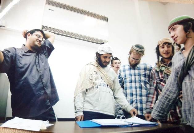 Gilad Sade, in white, with Itamar Ben Gvir, to his left, during Gvir's visit with alleged recruits during a trial in 2004. All the minors were convicted. Credit: Ilan Mizrahi.