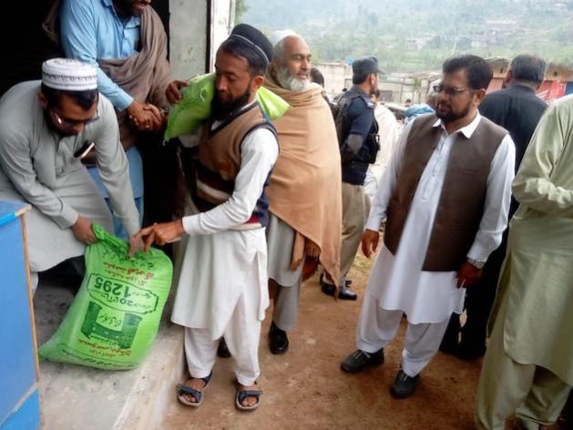 A man collects his ration at one of the Benazir Income Support Programme (BISP) collection points. The project, however, has resulted in deaths and injuries as people flocked to the collection points. Credit: Ashfaq Yusufzai/IPS