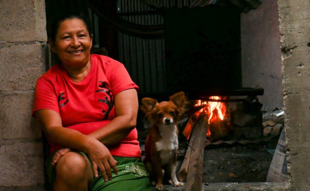 Cecilia Menjivar, a tortilla maker in San Salvador, the capital of El Salvador, takes a break from cooking corn in a pot that is one meter high and 50 centimeters in diameter, heated by a wood stove. Many women in urban and rural areas run these small businesses, aware of the damage to their health caused by the smoke, but the economic situation forces them to use firewood, which is much cheaper than liquefied gas. CREDIT: Edgardo Ayala / IPS