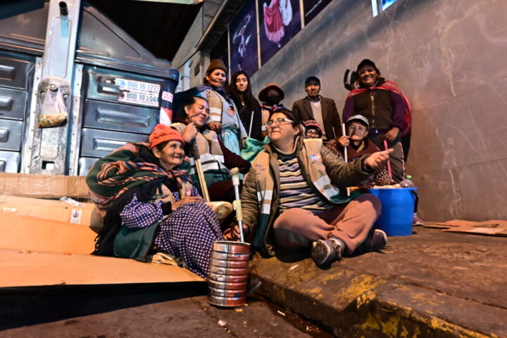 One of the groups of women of the Ecorecicladoras de La Paz association gather next to a municipal dumpster in a corner of Plaza Avaroa in Bolivia's political capital, after finishing their nightly collection of reusable materials. CREDIT: Franz Chávez / IPS