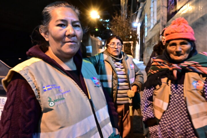 In the foreground, the secretary of Ecorecicladoras de La Paz, María Martínez (50), together with Carla Chávez (42) and her mother Leonarda Chávez (72) take a break from sorting through waste in the Sopocachi area of the Bolivian city of La Paz. CREDIT: Franz Chávez / IPS